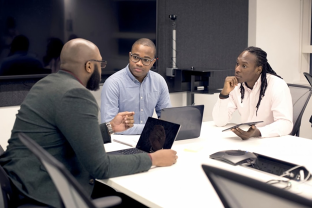 A team of professionals collaborating using AI-powered knowledge management software to streamline decision-making processes