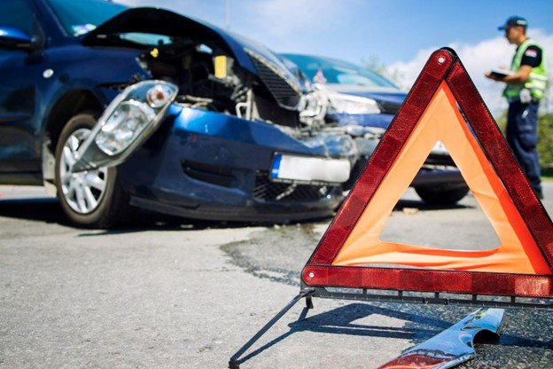 close up of wrecked car with orange triangle