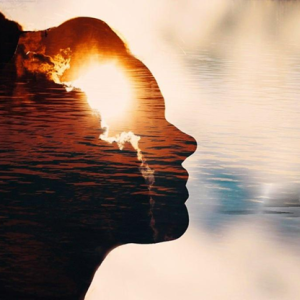 silhoutte of a womans face with water and sky