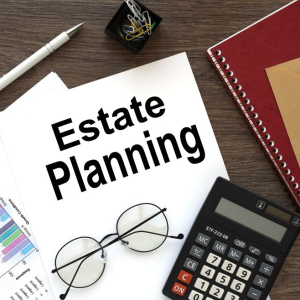 estate planning on paper with calculator and glasses laying on a table