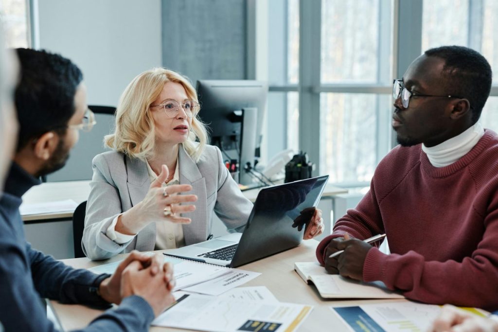 woman at the head of a table at a business meeting