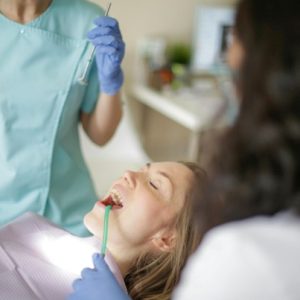 A person getting her teeth checked