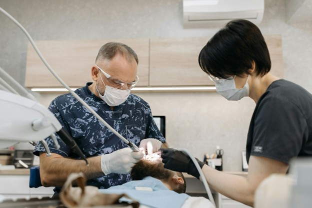 dentist working in patient's mouth