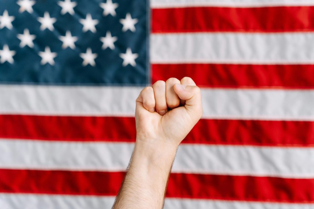 fist raised in front of american flag
