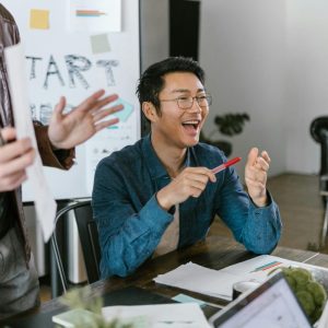 man sitting at a table doing a presentation