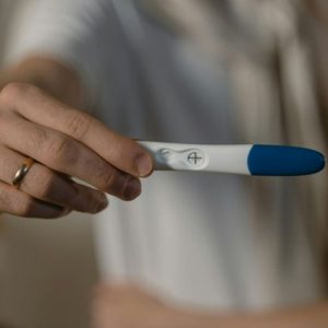 man holding a pregnancy test