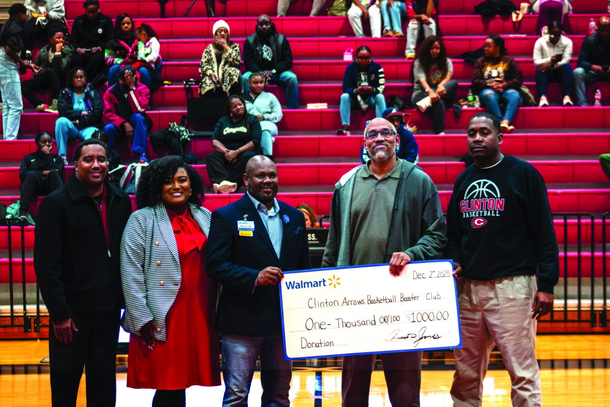 Walmart recently presented a donation to the Clinton Arrows Basketball Booster Club (CABBC), Pictured (l to r) are Robert Hampton, Jr., CABBC Executive Assistant Natalie Hampton, Walmart Manager Ramondo James, CABBC President James Eatmon and Arrows Assistant Athletic Director/Head Coach Joshua Luckett.