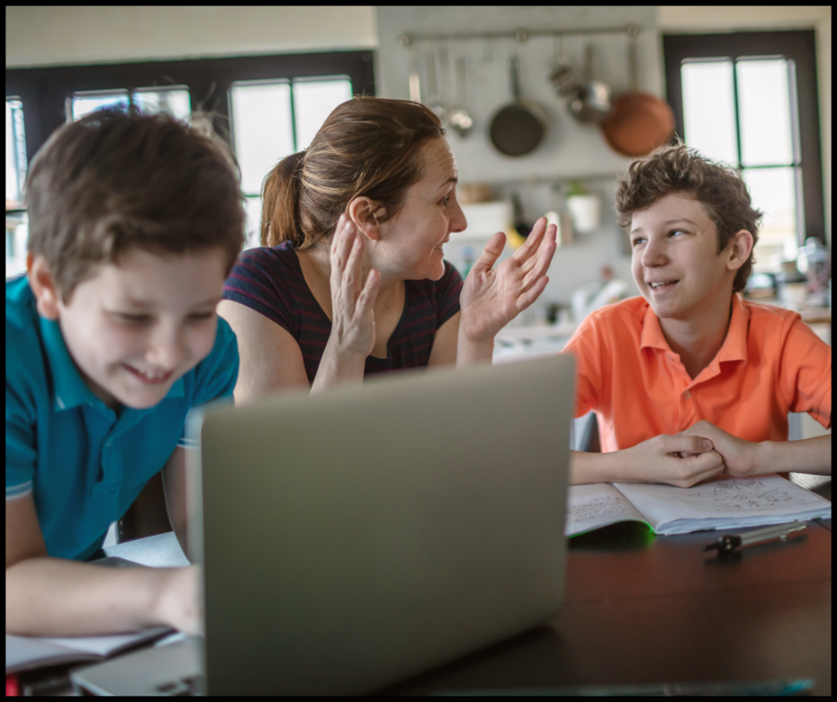 Mom and sons completing homeschool lesson on laptop