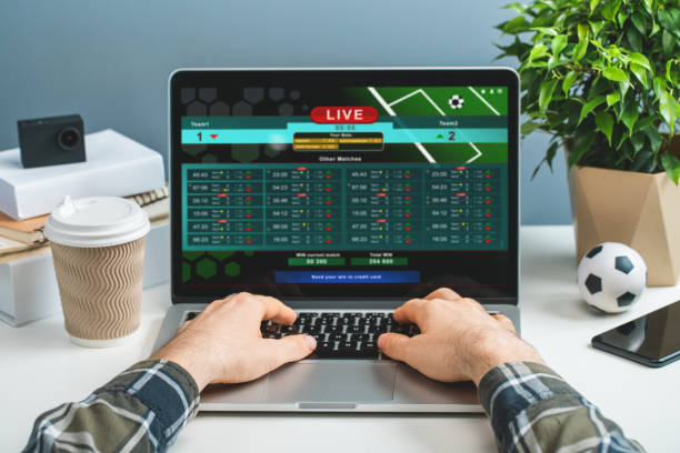 person on a computer playing caisno online