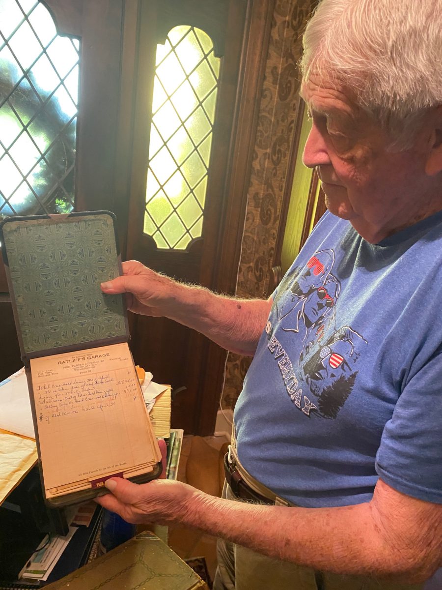 Ed Ratliff with long-ago Ratliff company papers, showing phone number 59. He remembers his mother Nell once lining a chest with ledger paper.