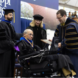 Flanked by his son, Jonathan "JP" Parke, left, and Stephanie Busbea, MC professor of art and dean of the School of Christian Studies, Humanities and the Arts, Ivan Parke receives a plaque denoting his status as MC professor emeritus of Christian Studies and Philosophy from MC President Blake Thompson.