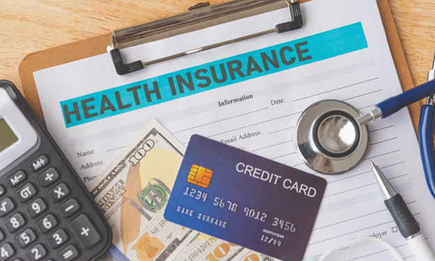 health insurance paperwork with credit card and money