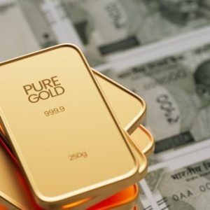 pure gold plates sitting on top of money