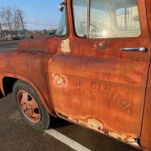 A closer look at the 1955 fire truck shows the markings barely visible on the rusty door.