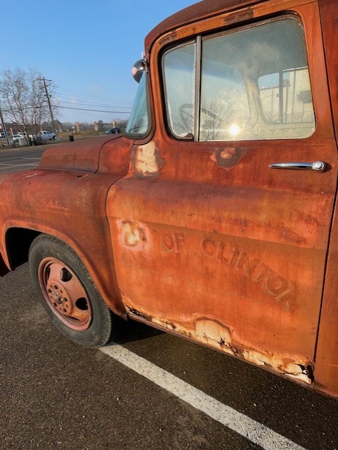 A closer look at the 1955 fire truck shows the markings barely visible on the rusty door.