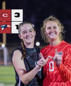 two female soccer players from Clinton high School make W shape with hand