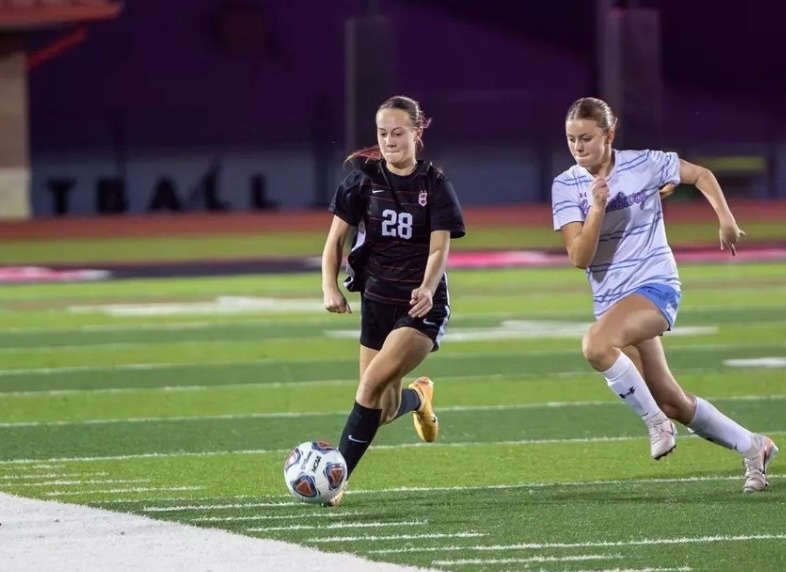 clinton arrows girls soccer player kicks ball
