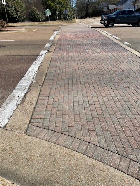 Traffic approaches one of the brick crosswalks on the Clinton Parkway.