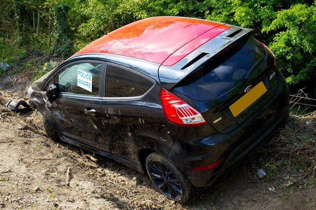 black car in ditch after wreck accident