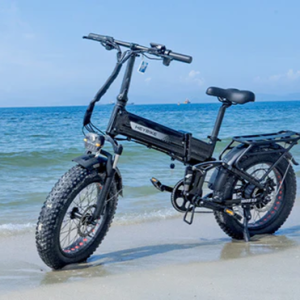 electric bike sitting on beach with water in the background