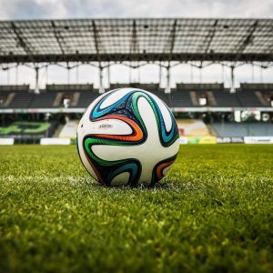 soccer ball sitting on a field in a stadium