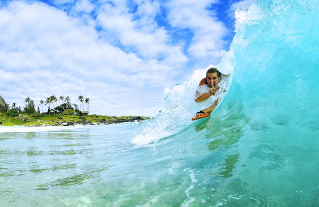 man on a surf board riding a small wave