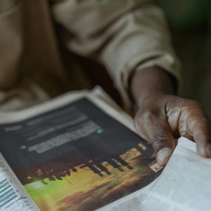 close up photo of someone holding a newspaper