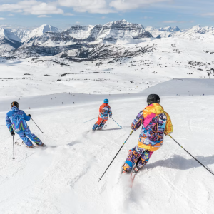 three people skiing down a mountain