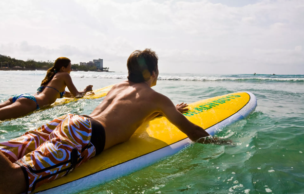 two people on surf boards waiting for waves