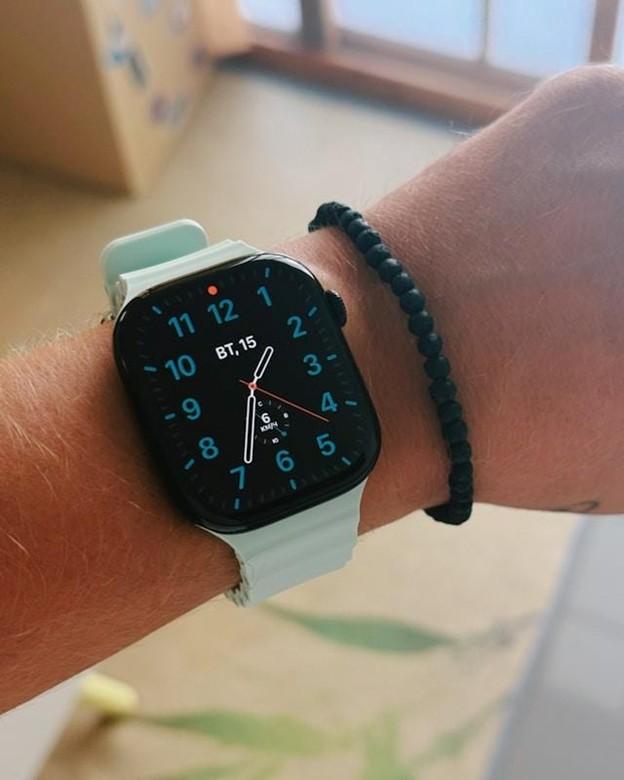 black face watch with blue band on a man's wrist