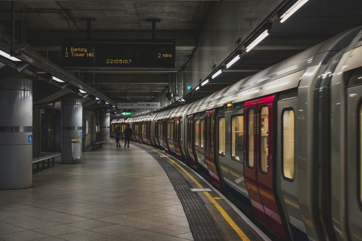 person standing near a train underground
