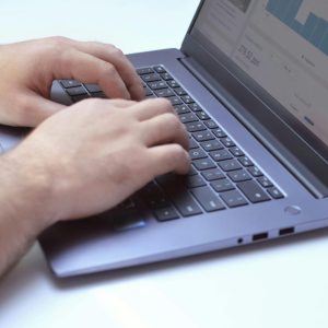 clost up of man's hands typing on a laptop computer