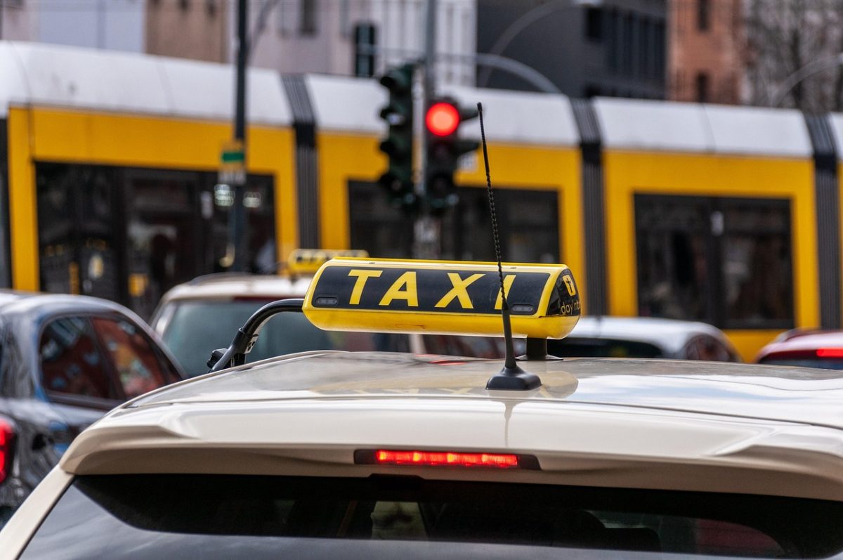 close up of a taxi sign on top of a car