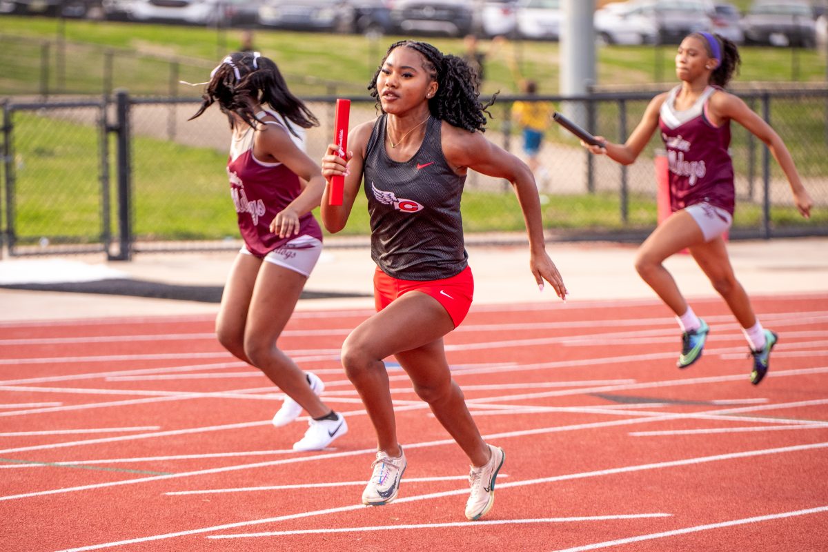clinton arrows girls track member running with baton