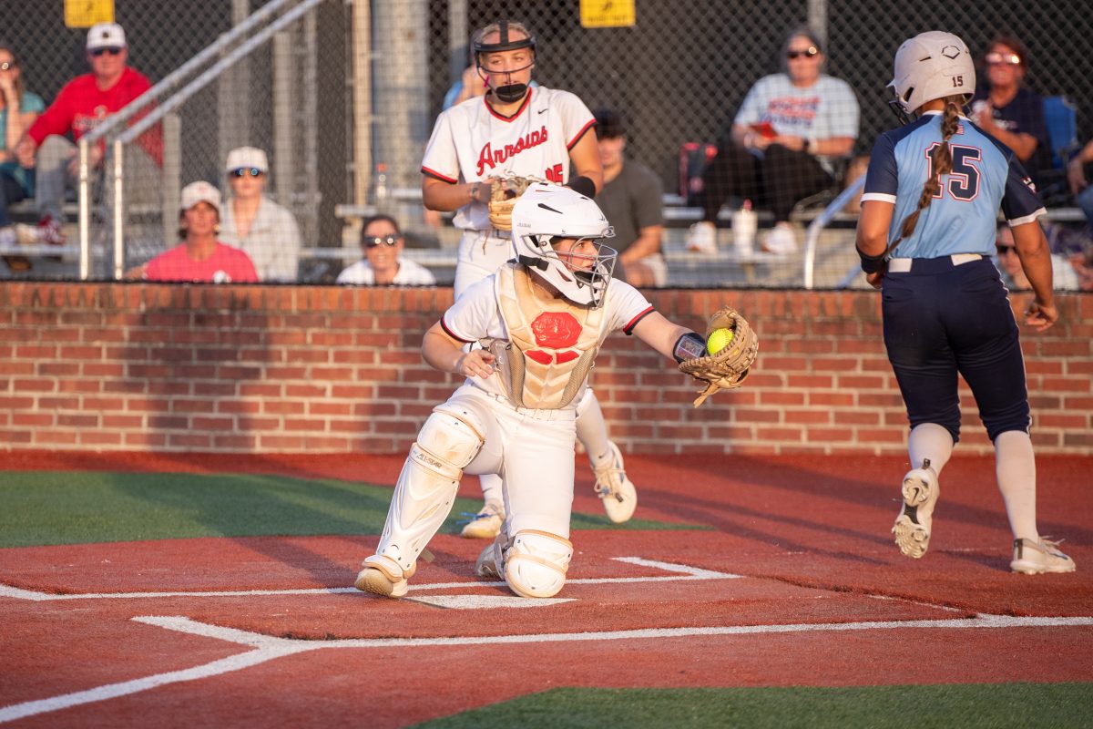 lady arrows softball catcher on knee catching ball