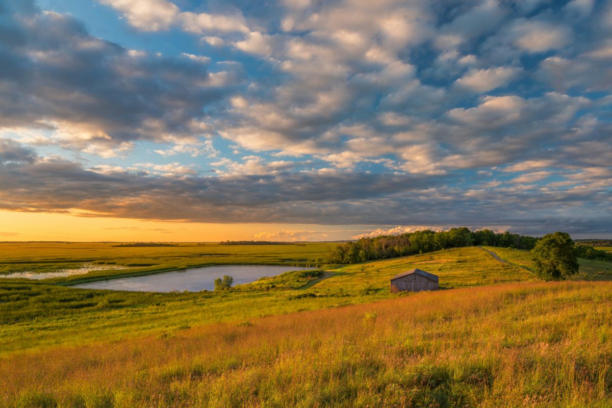 small house on a grassy hill in wisconsin
