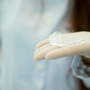 dentist holding clear aligners