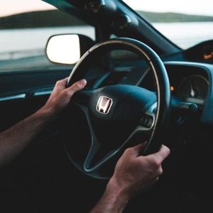 close up of hands on honda steering wheel