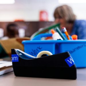 Close-up of tape dispenser in classroom setting.