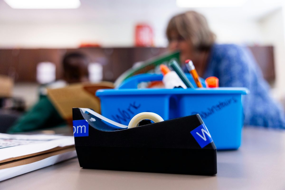 Close-up of tape dispenser in classroom setting.