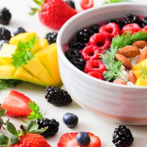 fruit in a bowl and spread out on table
