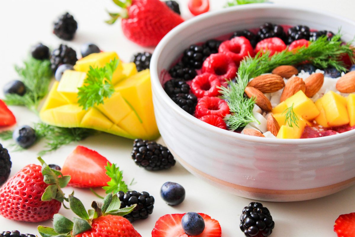 fruit in a bowl and spread out on table