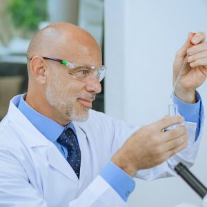 researcher holding dropper and test tube, photo by Kindel Media on Pexels