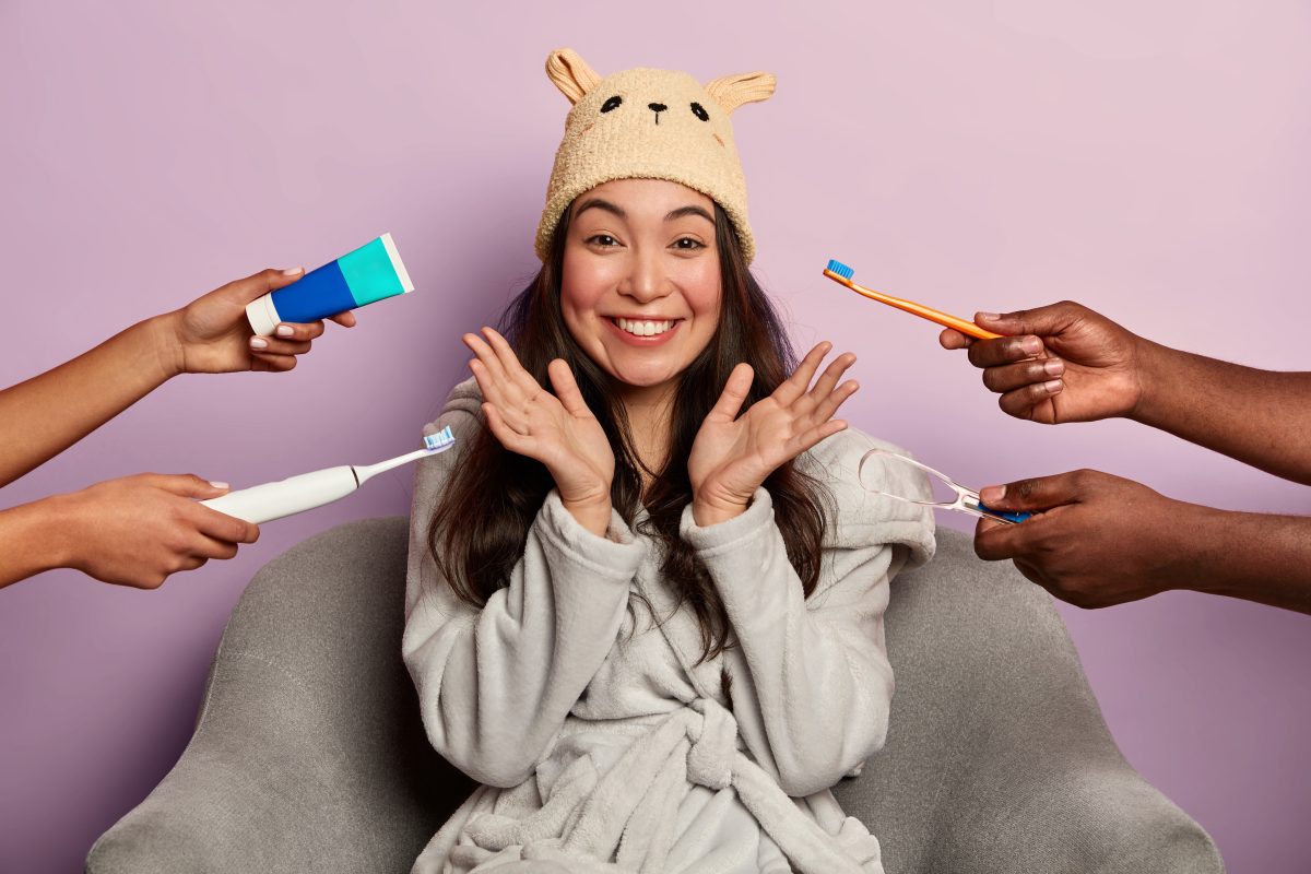  Portrait of young and beautiful woman smiling with toothbrush and toothpaste being handed over