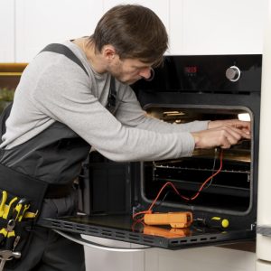 Service tech working on oven