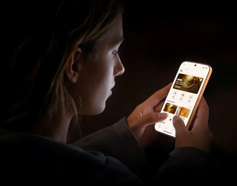 woman scrolling on phone in the dark