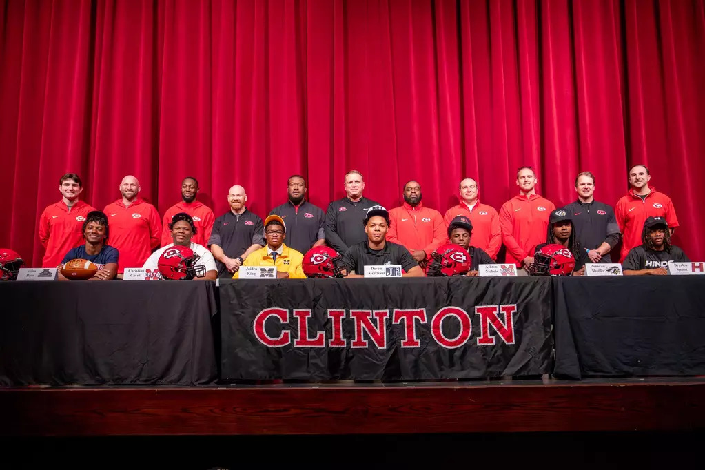 Pictured (l to r) in the front row are current Clinton High School seniors who recently signed to play football at the next level: Miles Bass (SMCC), Christian Cavett (MDCC), Jaiden King (MGCCC), Davon Merchant (JSU), Ashton Nichols (MDCC), Donovan Shaifer (ECCC) and Braylen Spann (HCC). Clinton Arrows coaching staff is pictured behind the players.