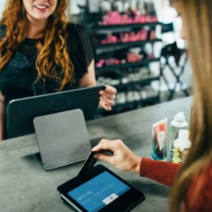 woman making a payment at point of sale system in a store