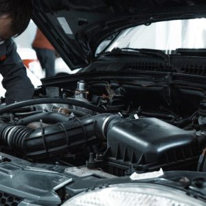 automotive working under the hood of a car