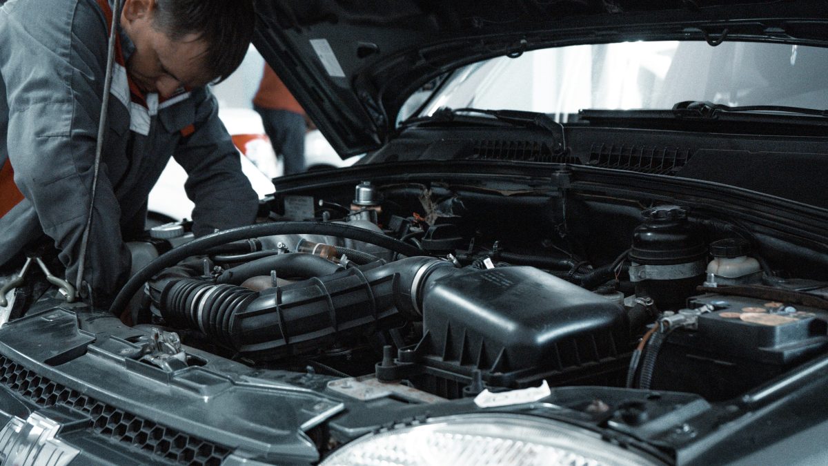 automotive working under the hood of a car